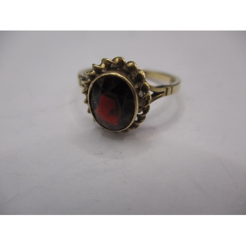 12 - A vintage 9ct gold and garnet dress ring, approx. ring size ‘Q’, approx. weight 2.4g in useable pre-... 