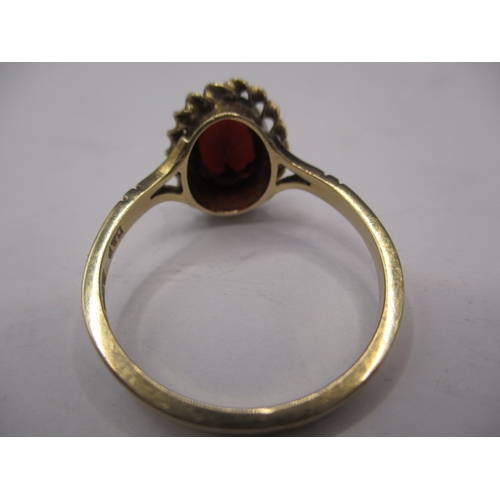 12 - A vintage 9ct gold and garnet dress ring, approx. ring size ‘Q’, approx. weight 2.4g in useable pre-... 