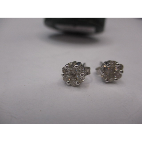 58 - A pair of white gold and diamond 7 stone stud earrings, in useable pre-owned condition