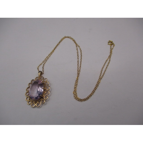 60 - A 9ct gold necklace pendant with large amethyst? Stone and unmarked yellow metal chain, in good pre-... 