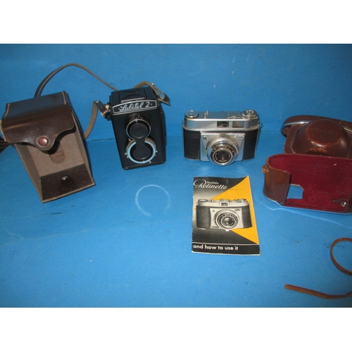 288 - A vintage Lubitel 2 camera and a Kodak Retinette, both in used condition with leather cases and not ... 