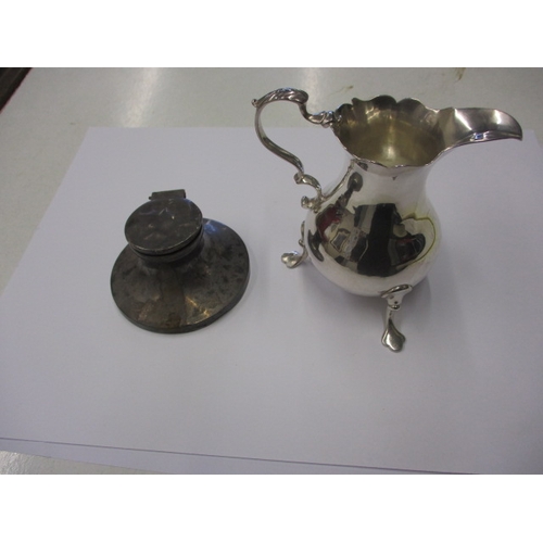 An antique sterling silver cream jug and a small silver inkwell, both in used condition, approx. weight of jug 81.5g