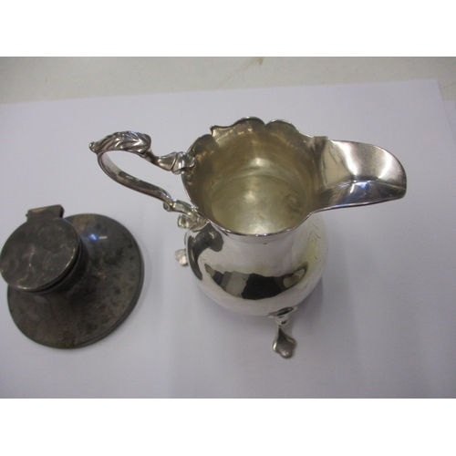 219 - An antique sterling silver cream jug and a small silver inkwell, both in used condition, approx. wei... 