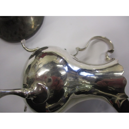 219 - An antique sterling silver cream jug and a small silver inkwell, both in used condition, approx. wei... 