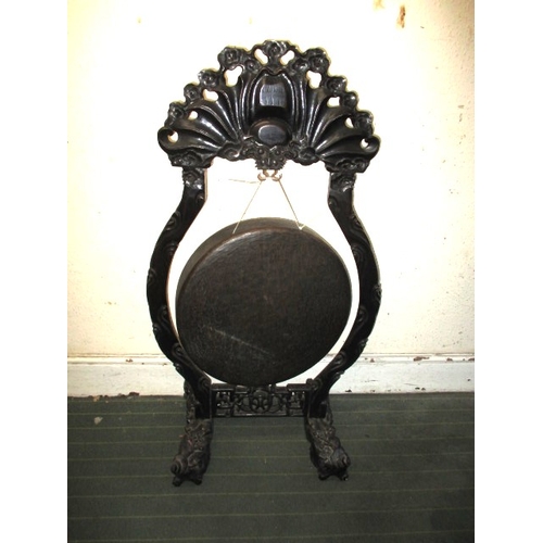 320 - A large Tibetan style temple gong, on carved wood stand, approx. height 112cm, in useable pre-owned ... 