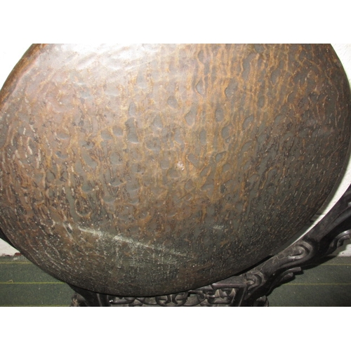 320 - A large Tibetan style temple gong, on carved wood stand, approx. height 112cm, in useable pre-owned ... 