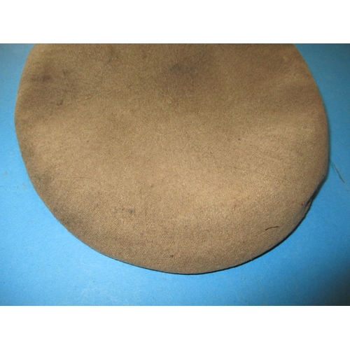 276 - A 1944 dated sand coloured military beret by Kangol, outline of where a badge was fitted which was p... 