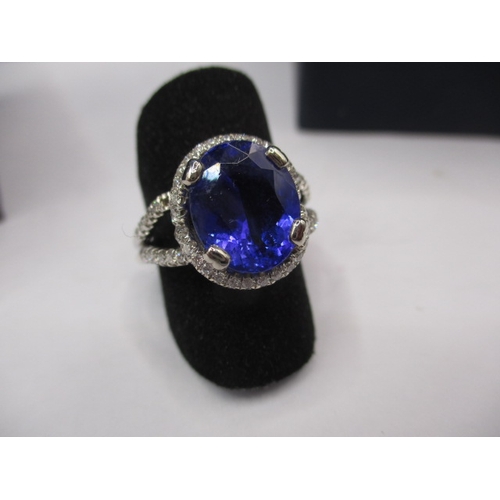 24 - An 18ct white gold diamond and tanzanite ring, the large central AAA quality stone measuring approx.... 