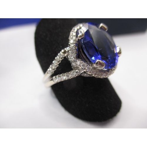 24 - An 18ct white gold diamond and tanzanite ring, the large central AAA quality stone measuring approx.... 