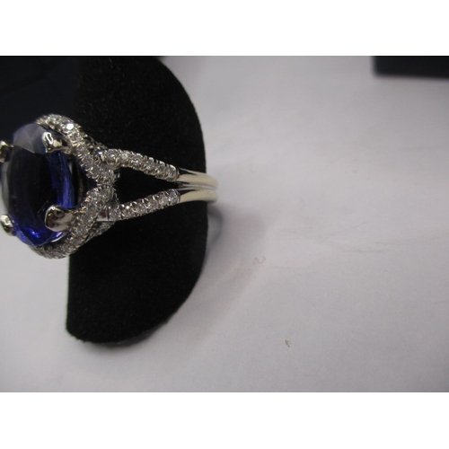 24 - An 18ct white gold diamond and tanzanite ring, the large central AAA quality stone measuring approx.... 