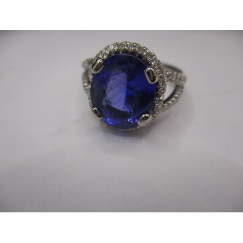 24 - An 18ct white gold diamond and tanzanite ring, the large central AAA quality stone measuring approx.... 