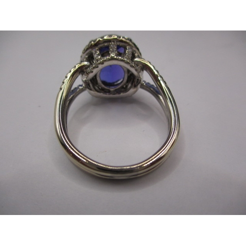 24 - An 18ct white gold diamond and tanzanite ring, the large central AAA quality stone measuring approx.... 