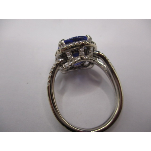 24 - An 18ct white gold diamond and tanzanite ring, the large central AAA quality stone measuring approx.... 