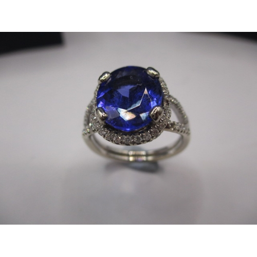 24 - An 18ct white gold diamond and tanzanite ring, the large central AAA quality stone measuring approx.... 