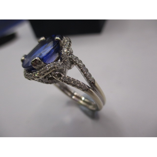 24 - An 18ct white gold diamond and tanzanite ring, the large central AAA quality stone measuring approx.... 