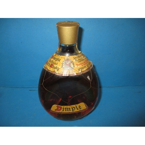 339 - A bottle of 1950s Dimple Scotch whisky, with original mesh outer and labels