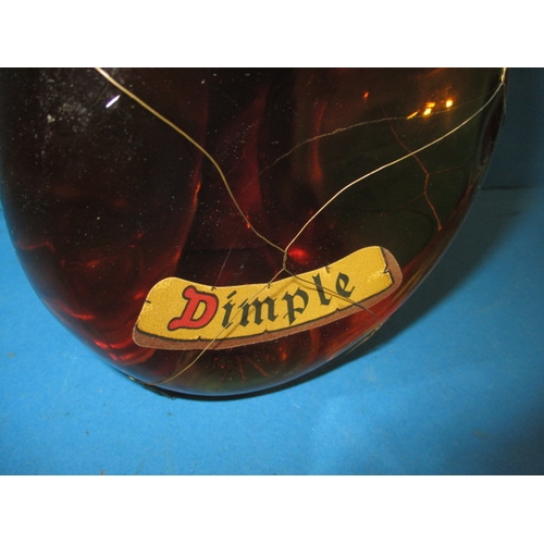 339 - A bottle of 1950s Dimple Scotch whisky, with original mesh outer and labels