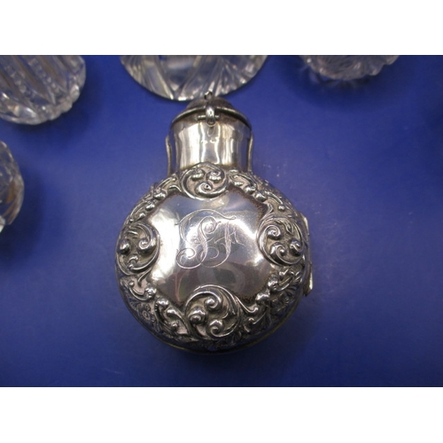 242 - A parcel of silver topped bottles and jars, to include a cased smelling salts bottle, all with gener... 