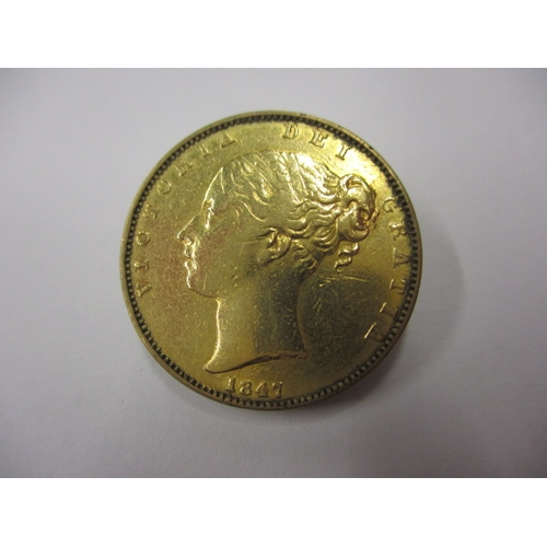 148 - A Victorian gold sovereign dated 1847, a circulated coin with fine definition of features, having th... 