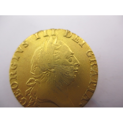 157 - A George III gold spade guinea dated 1787, a circulated coin with scuff to face and signs of being i... 