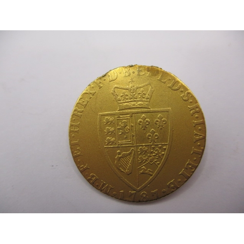 157 - A George III gold spade guinea dated 1787, a circulated coin with scuff to face and signs of being i... 