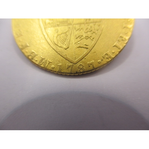 157 - A George III gold spade guinea dated 1787, a circulated coin with scuff to face and signs of being i... 