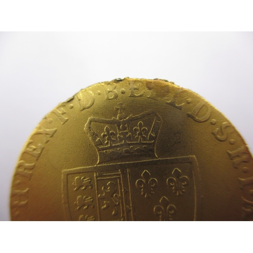 157 - A George III gold spade guinea dated 1787, a circulated coin with scuff to face and signs of being i... 