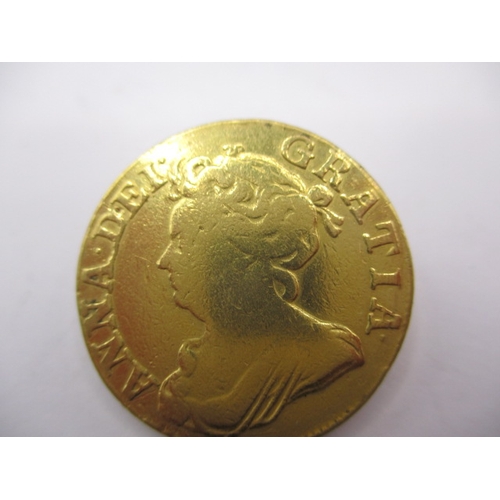 158 - A Queen Anne gold guinea dated 1710, a circulated coin with reasonable definition of features