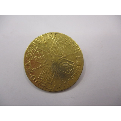 158 - A Queen Anne gold guinea dated 1710, a circulated coin with reasonable definition of features