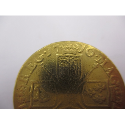 158 - A Queen Anne gold guinea dated 1710, a circulated coin with reasonable definition of features