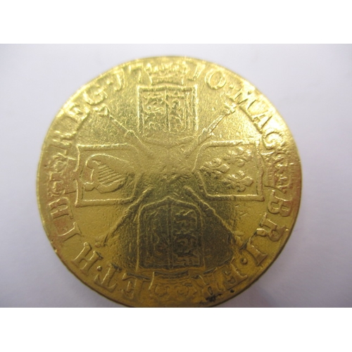 158 - A Queen Anne gold guinea dated 1710, a circulated coin with reasonable definition of features