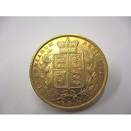 144 - A Victorian shield back sovereign dated 1873, with die 7 mark, a circulated coin with very fine defi... 