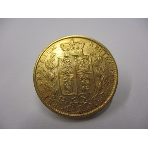 145 - A Victorian shield back sovereign dated 1864, with die 95 mark, a circulated coin with very fine def... 