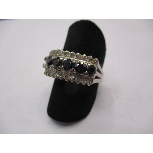 28 - A 14k white gold diamond and sapphire ring, approx. ring size ‘O’, approx. weight 5.4g, having one s... 