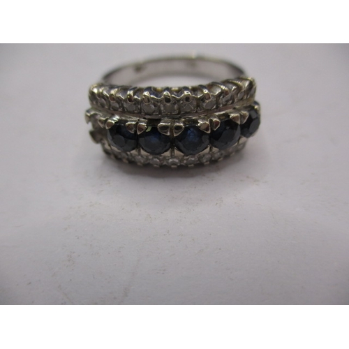 28 - A 14k white gold diamond and sapphire ring, approx. ring size ‘O’, approx. weight 5.4g, having one s... 