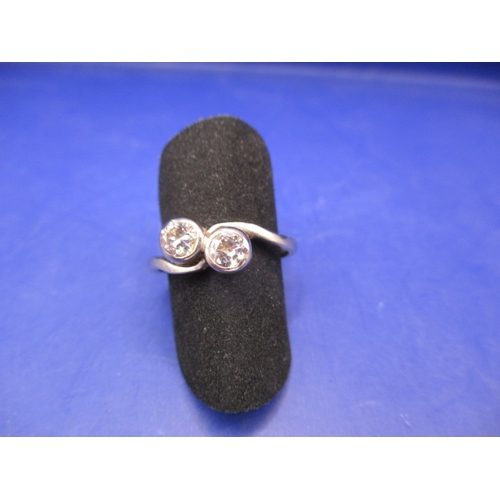 A 585 white gold 2 stone diamond cross over ring, approx. ring size ‘O’, approx. weight 2.8g in useable pre-owned condition with inscription inside