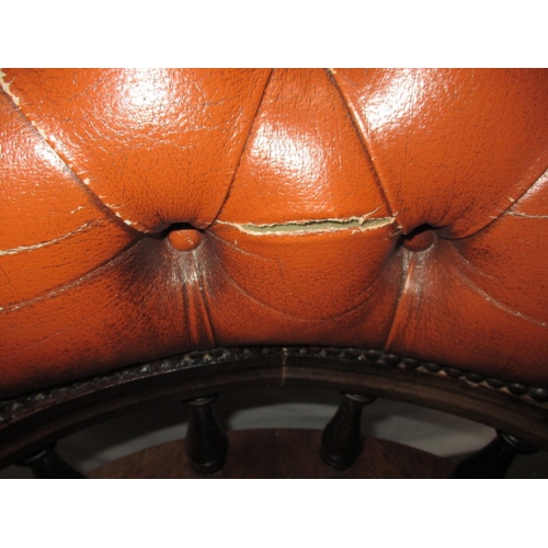 317 - A rust colour leather office chair, having a small split to one fold and general use related marks