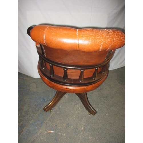 317 - A rust colour leather office chair, having a small split to one fold and general use related marks