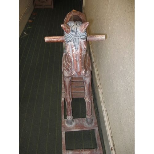 323 - A vintage carved wood rocking horse on bow rocker, in useable pre-owned condition, approx. length 12... 