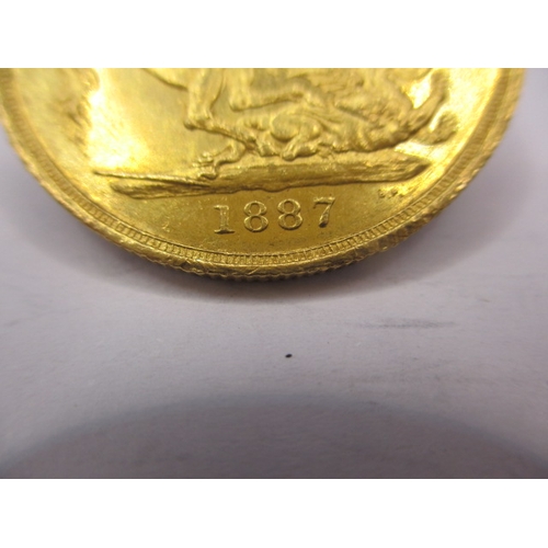 155 - A Victorian gold double sovereign dated 1887, a circulated coin with very fine definition of feature... 