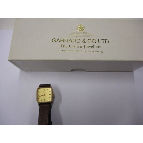 104 - A 1980s Garrards 9ct gold watch in original Garrard & CO box, having dedication on back from Ford mo... 