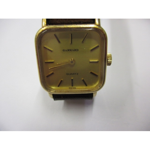 104 - A 1980s Garrards 9ct gold watch in original Garrard & CO box, having dedication on back from Ford mo... 