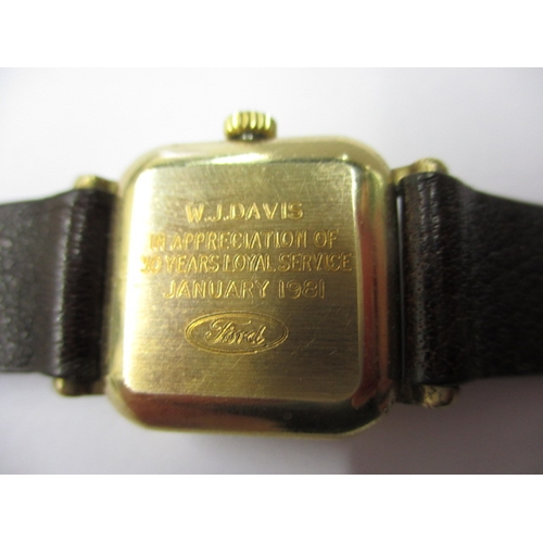 104 - A 1980s Garrards 9ct gold watch in original Garrard & CO box, having dedication on back from Ford mo... 