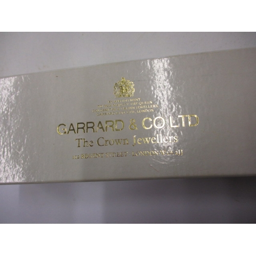 104 - A 1980s Garrards 9ct gold watch in original Garrard & CO box, having dedication on back from Ford mo... 