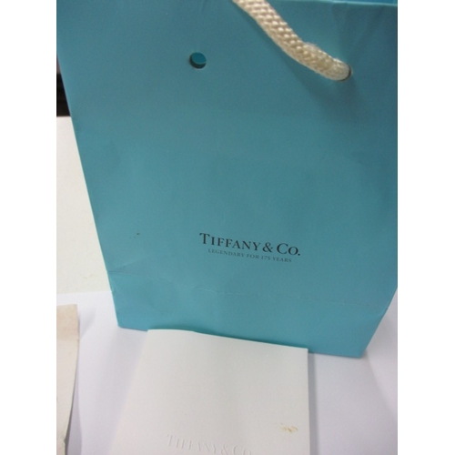 135 - A genuine Tiffany & Co silver interlocking ring set, with original purchase receipt and bag, approx.... 