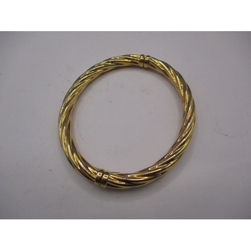 62 - A 750 yellow gold bangle, approx. weight 13g, in useable pre-owned condition with working clasp