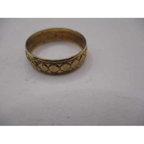 42 - A 750 yellow gold wedding band with geometric pattern, approx. ring size ‘R’ approx. width 5.7mm, ap... 