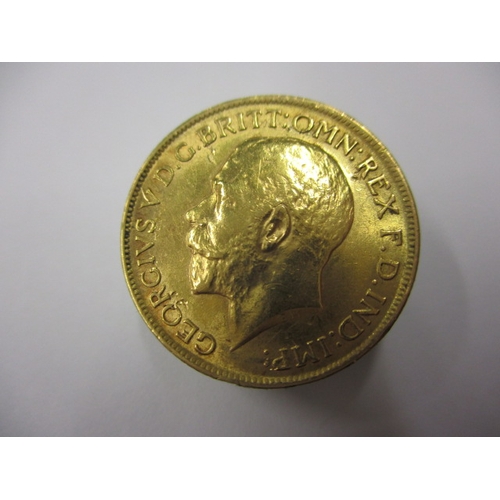 A George V gold sovereign dated 1911, a circulated coin with fine definition of features