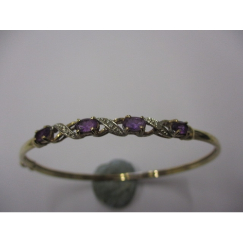 71 - A vintage 9ct gold diamond and amethyst bangle, with working clasp, approx. weight 4.3g