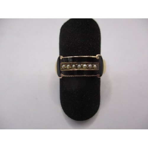 44 - An antique yellow gold mourning ring, having black enamel band with seed pearls to centre, approx. r... 